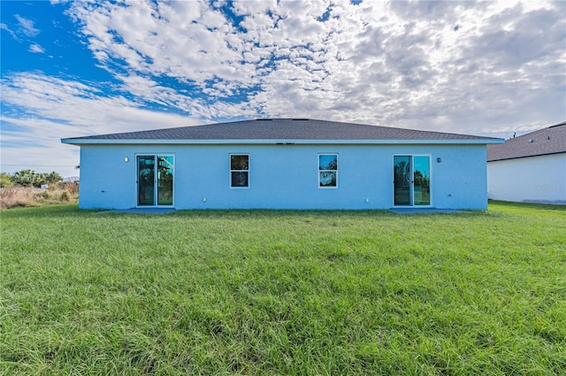 rear view of house with a yard