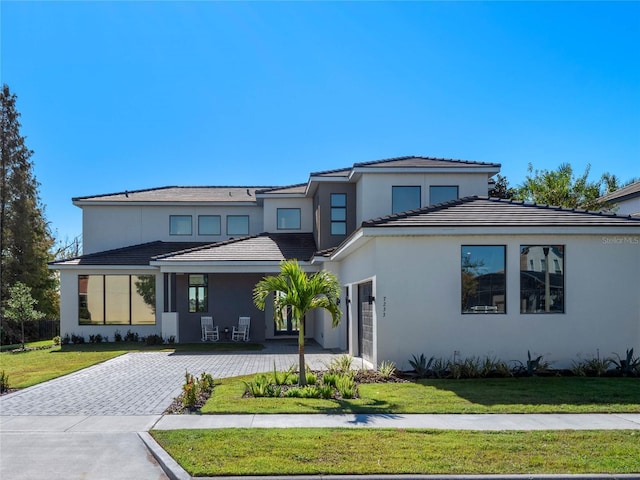 view of front facade with a garage and a front lawn