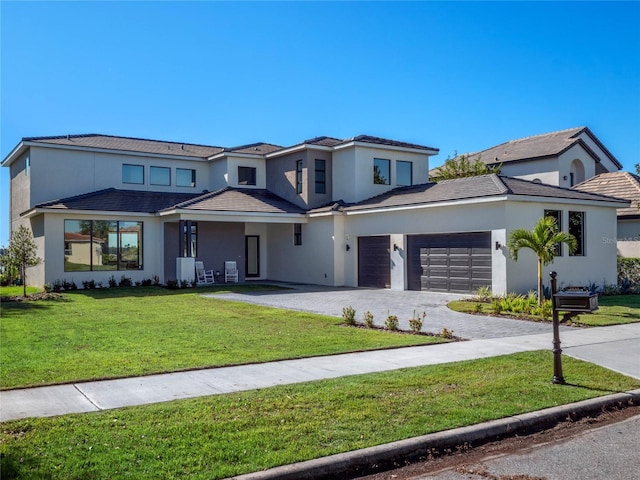 view of front facade with a garage and a front lawn