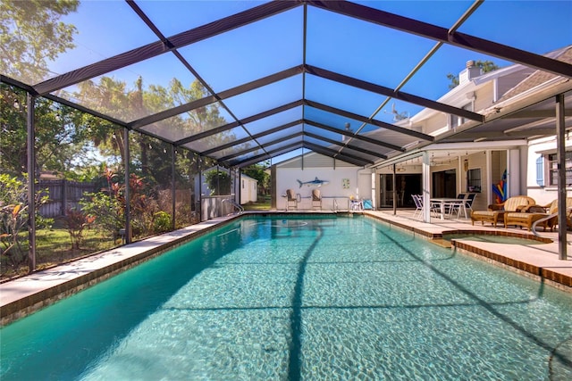 view of swimming pool featuring glass enclosure, a patio area, and ceiling fan