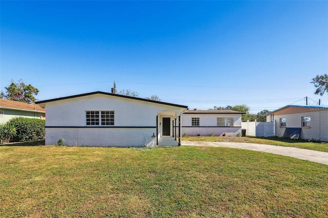 ranch-style home with a front lawn