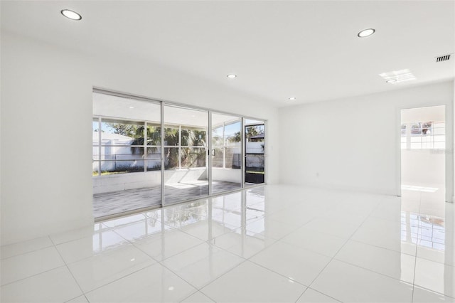 spare room with plenty of natural light and light tile patterned flooring