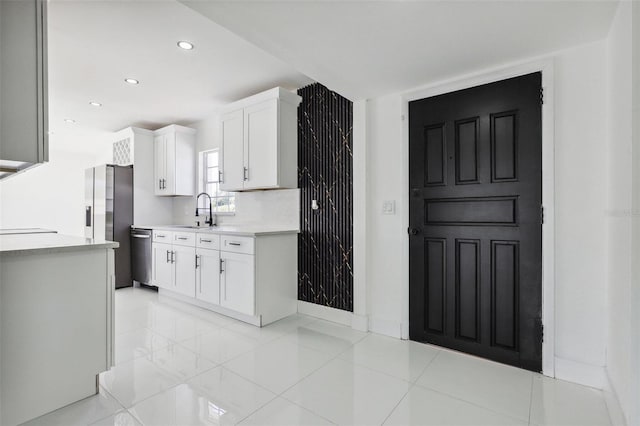 kitchen with white cabinets, sink, and appliances with stainless steel finishes