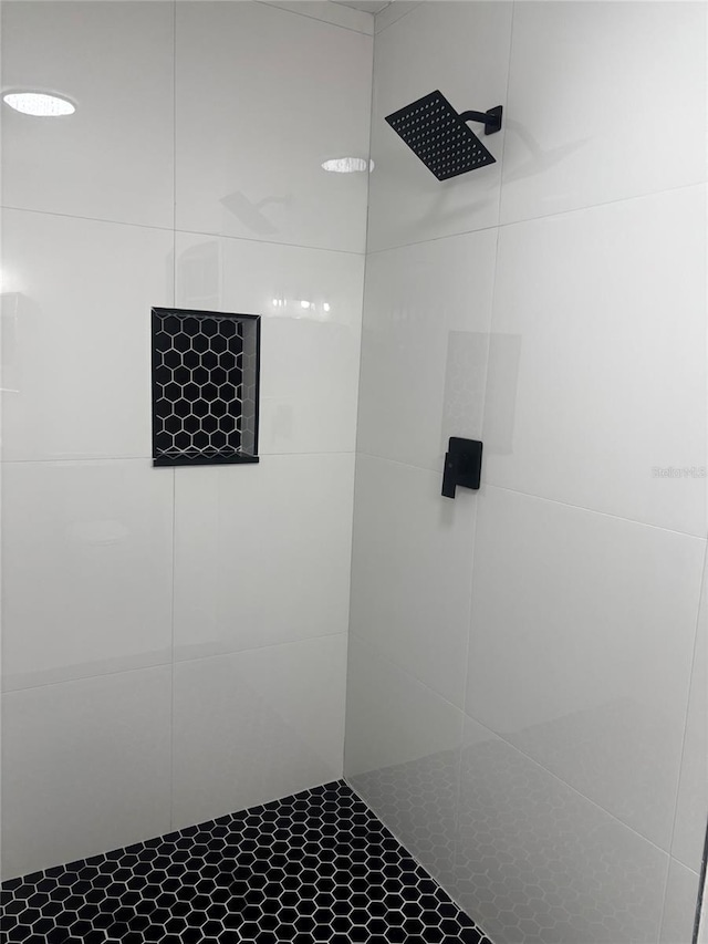 bathroom with tiled shower