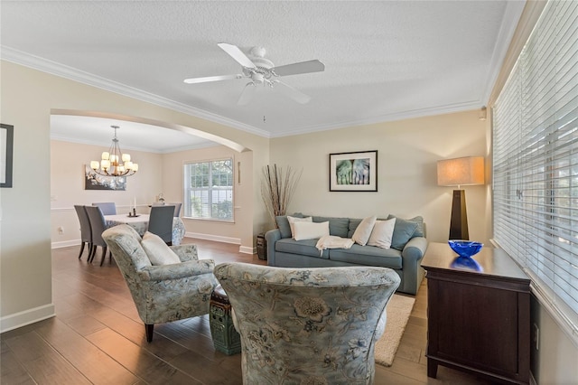 living room with ceiling fan with notable chandelier, hardwood / wood-style floors, a textured ceiling, and ornamental molding