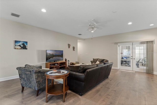 living room featuring french doors, light hardwood / wood-style floors, and ceiling fan