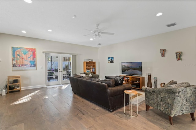 living room featuring french doors, hardwood / wood-style flooring, and ceiling fan