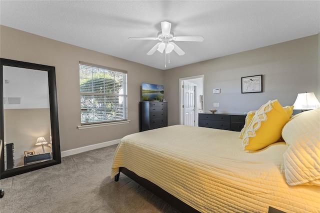 bedroom featuring ceiling fan, carpet floors, and a textured ceiling