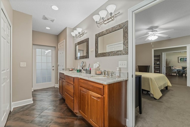 bathroom with vanity, a textured ceiling, ceiling fan, and tile patterned flooring