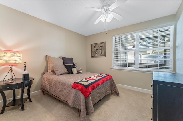 bedroom featuring ceiling fan and light carpet