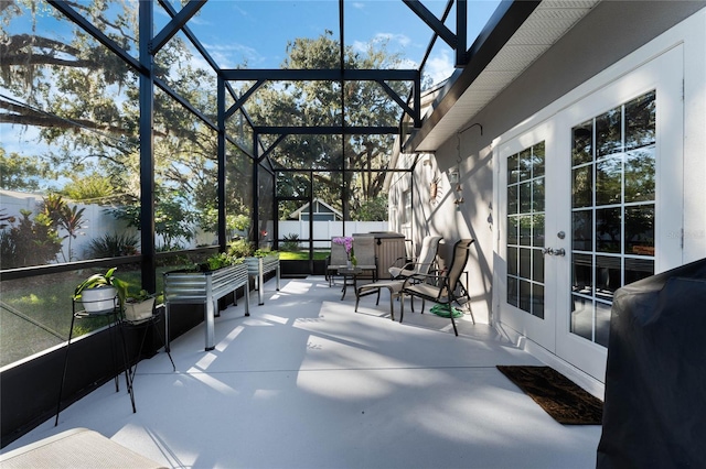 view of patio featuring glass enclosure and french doors