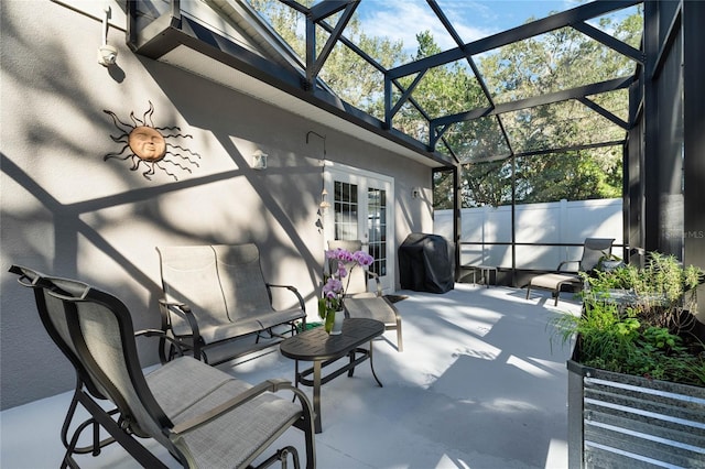 view of patio featuring a lanai and area for grilling