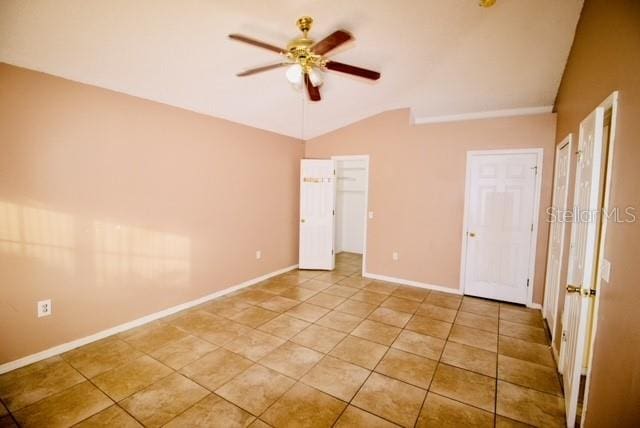 unfurnished bedroom with vaulted ceiling, ceiling fan, and light tile patterned flooring