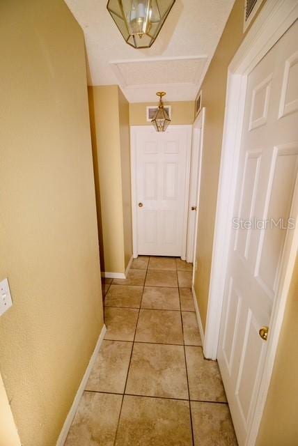 corridor featuring light tile patterned floors