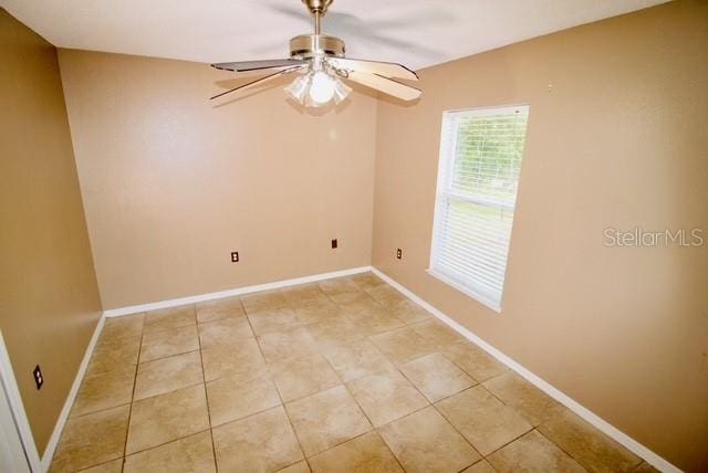 unfurnished room with ceiling fan and light tile patterned floors