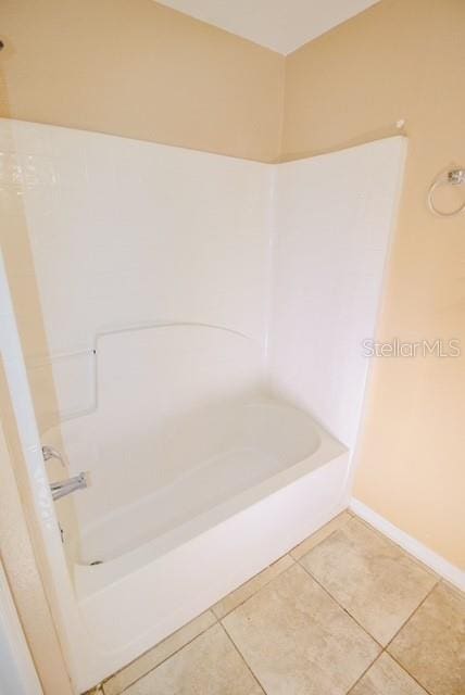 bathroom featuring tile patterned floors and bathtub / shower combination