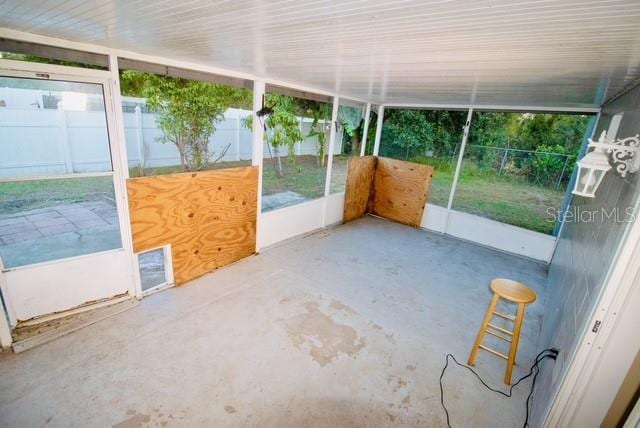 unfurnished sunroom featuring a wealth of natural light