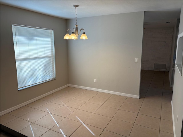 unfurnished room featuring light tile patterned floors and a chandelier