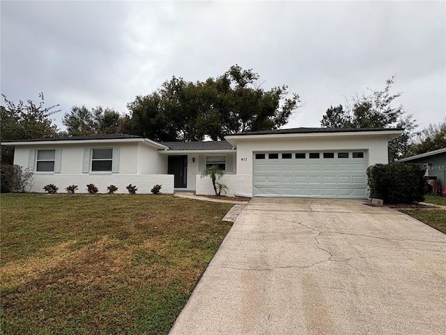 ranch-style house featuring a garage and a front lawn