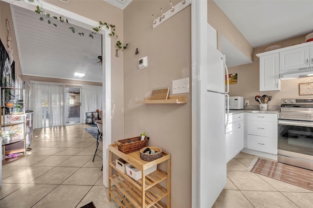 kitchen with ornamental molding, extractor fan, stainless steel electric range oven, light tile patterned floors, and white cabinetry