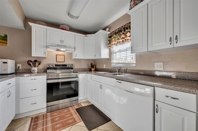 kitchen with sink, white cabinets, light tile patterned flooring, and white appliances