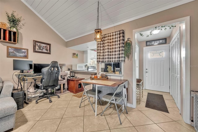 interior space featuring vaulted ceiling, crown molding, and light tile patterned flooring