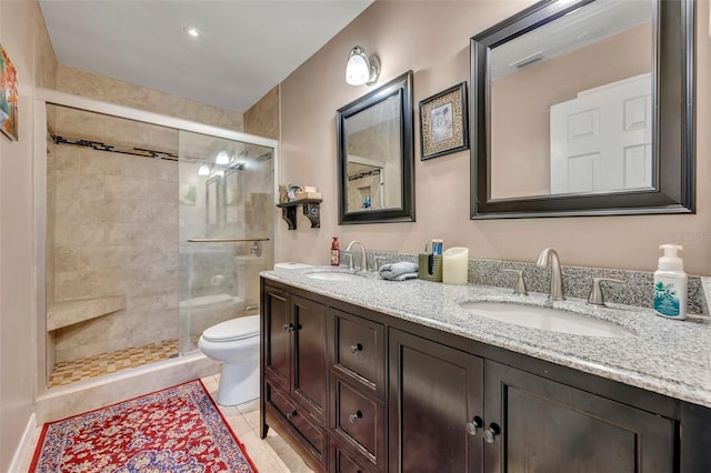 bathroom with tile patterned flooring, vanity, toilet, and a shower with shower door