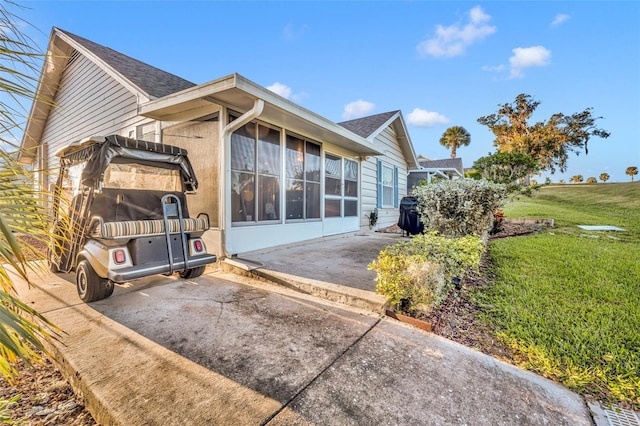 back of property with a yard and a patio