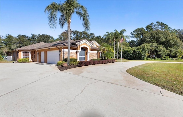 view of front of property with a front yard and a garage