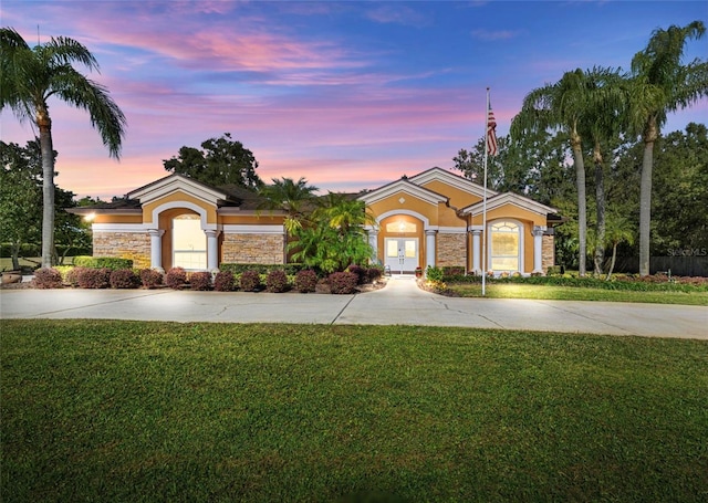 view of front of home featuring french doors and a yard