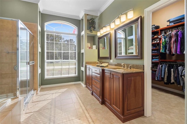 bathroom with tile patterned floors, vanity, crown molding, and walk in shower