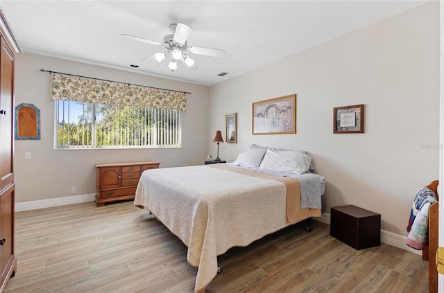 bedroom with ceiling fan and light wood-type flooring