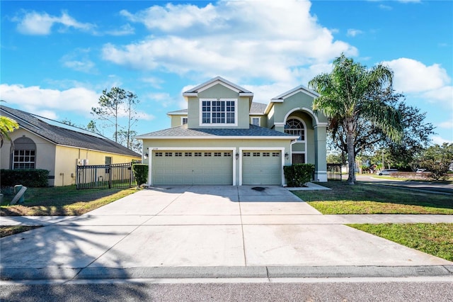 view of front of home featuring a front yard and a garage