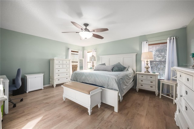 bedroom featuring light wood-type flooring and ceiling fan