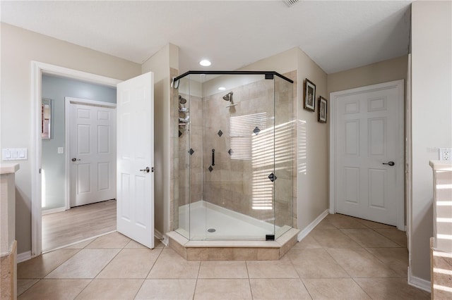 bathroom with tile patterned floors and walk in shower