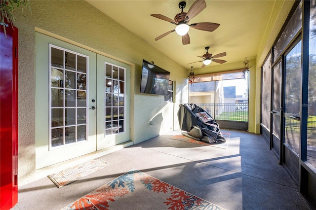 sunroom featuring ceiling fan and french doors