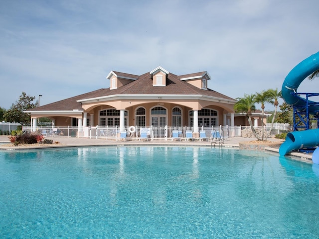 view of pool with a patio area and a water slide