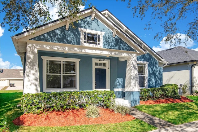 view of front of house with covered porch and a front yard