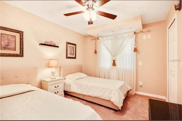 bedroom featuring light carpet and ceiling fan