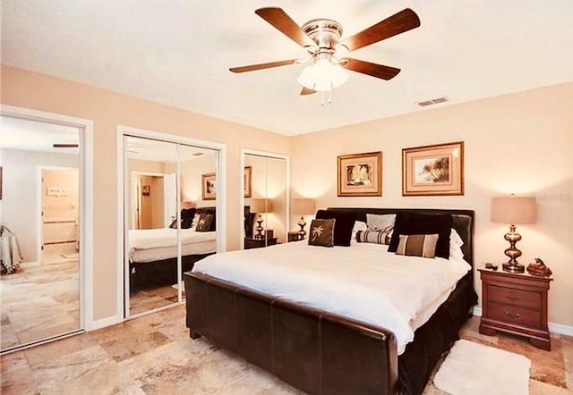 bedroom featuring multiple closets and ceiling fan