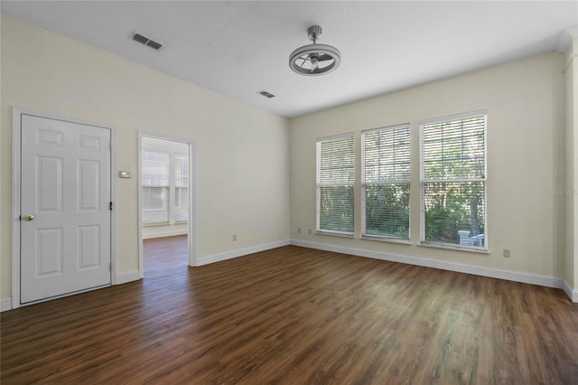 empty room with dark hardwood / wood-style floors