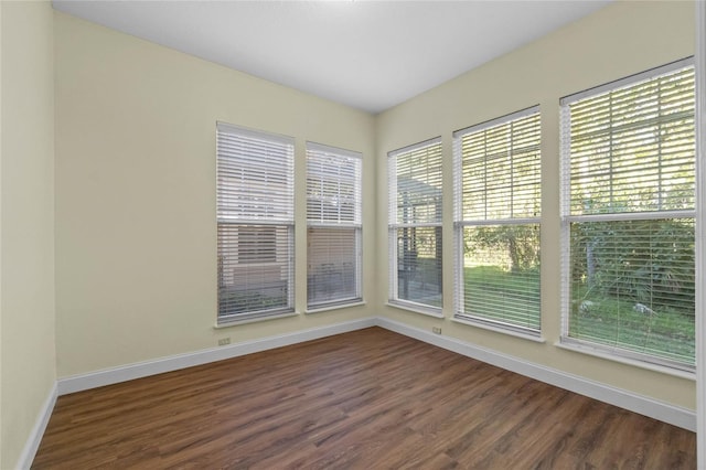 spare room with dark hardwood / wood-style floors