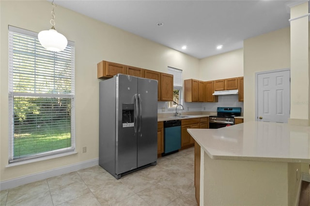 kitchen with appliances with stainless steel finishes, a wealth of natural light, hanging light fixtures, and sink