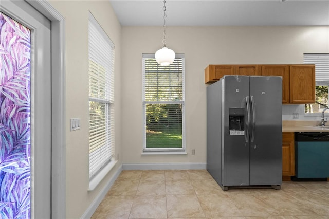 kitchen featuring light tile patterned flooring, sink, stainless steel appliances, and hanging light fixtures