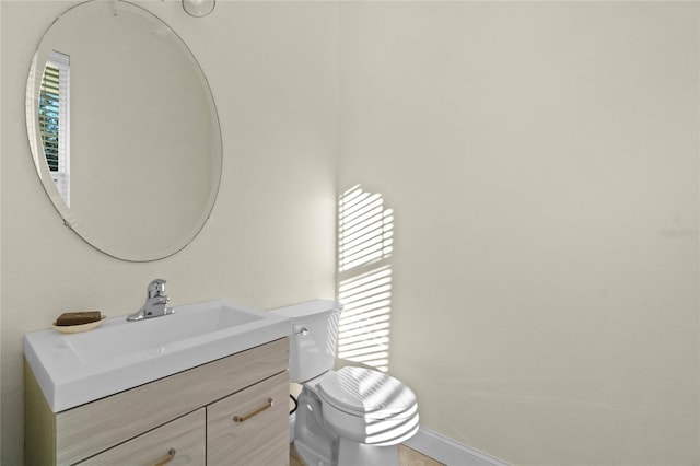 bathroom with vanity, toilet, and a wealth of natural light