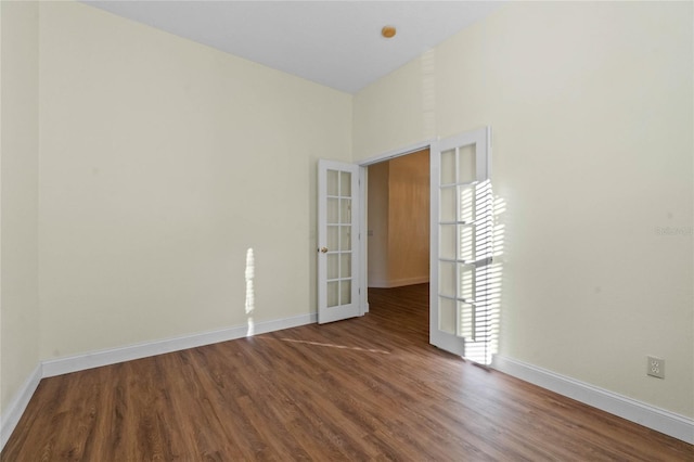 empty room featuring french doors and hardwood / wood-style floors