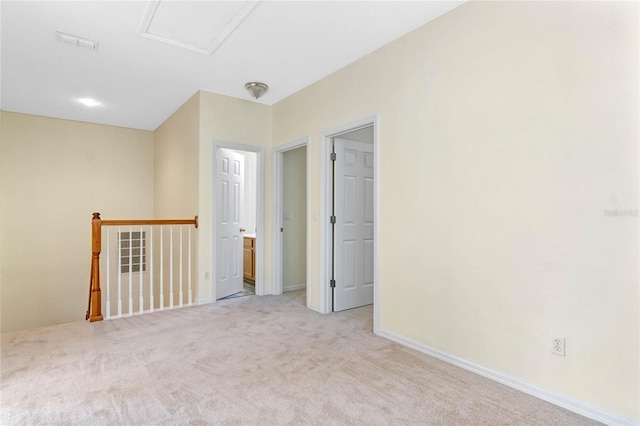 unfurnished room with light colored carpet