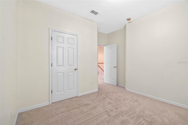 unfurnished bedroom with light carpet