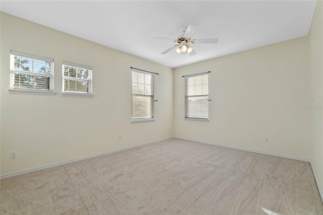 carpeted spare room featuring ceiling fan