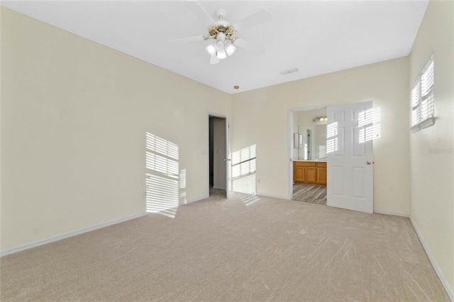 carpeted empty room featuring ceiling fan